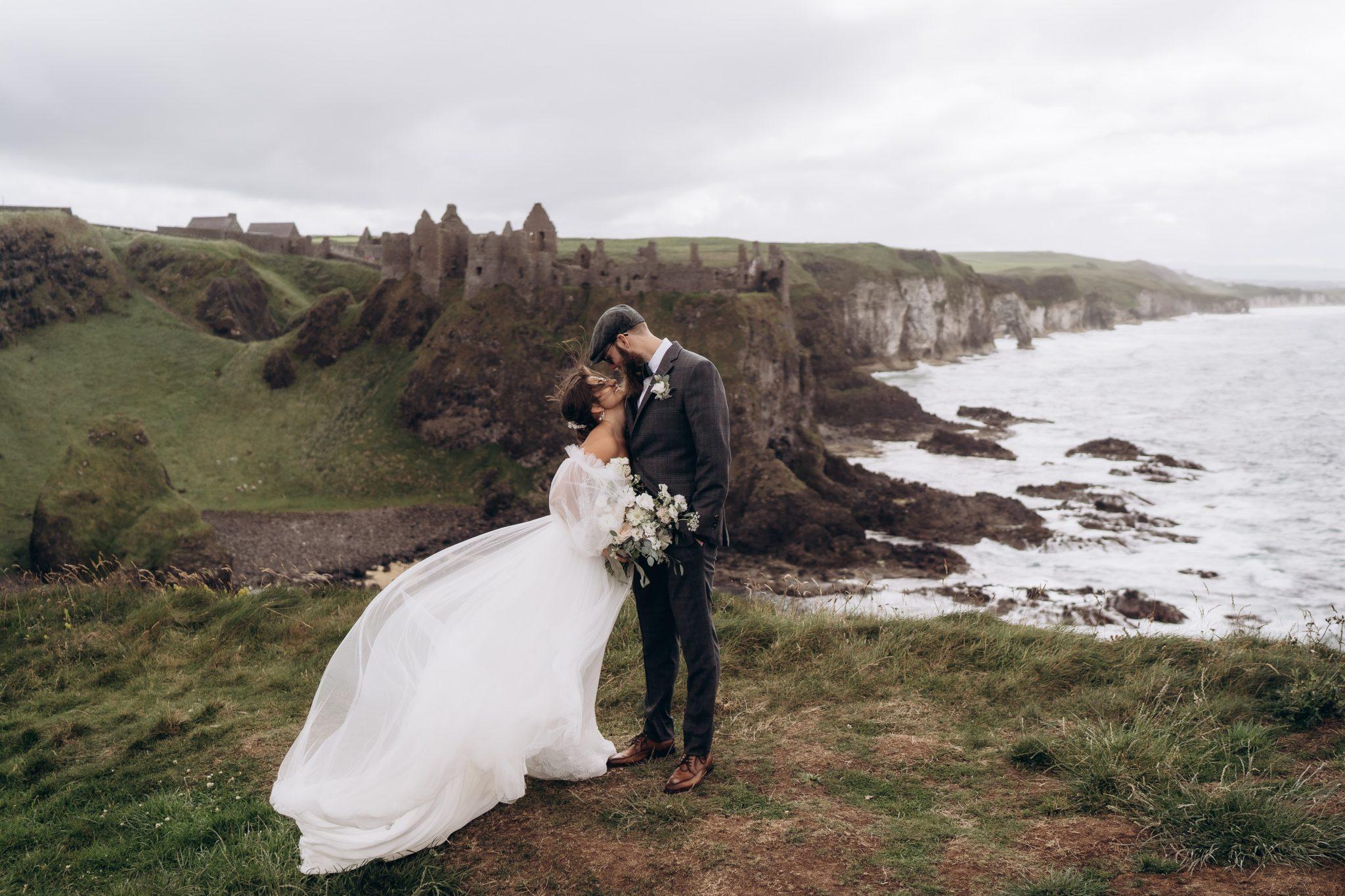Couple embracing during their Dunluce Castle elopement
